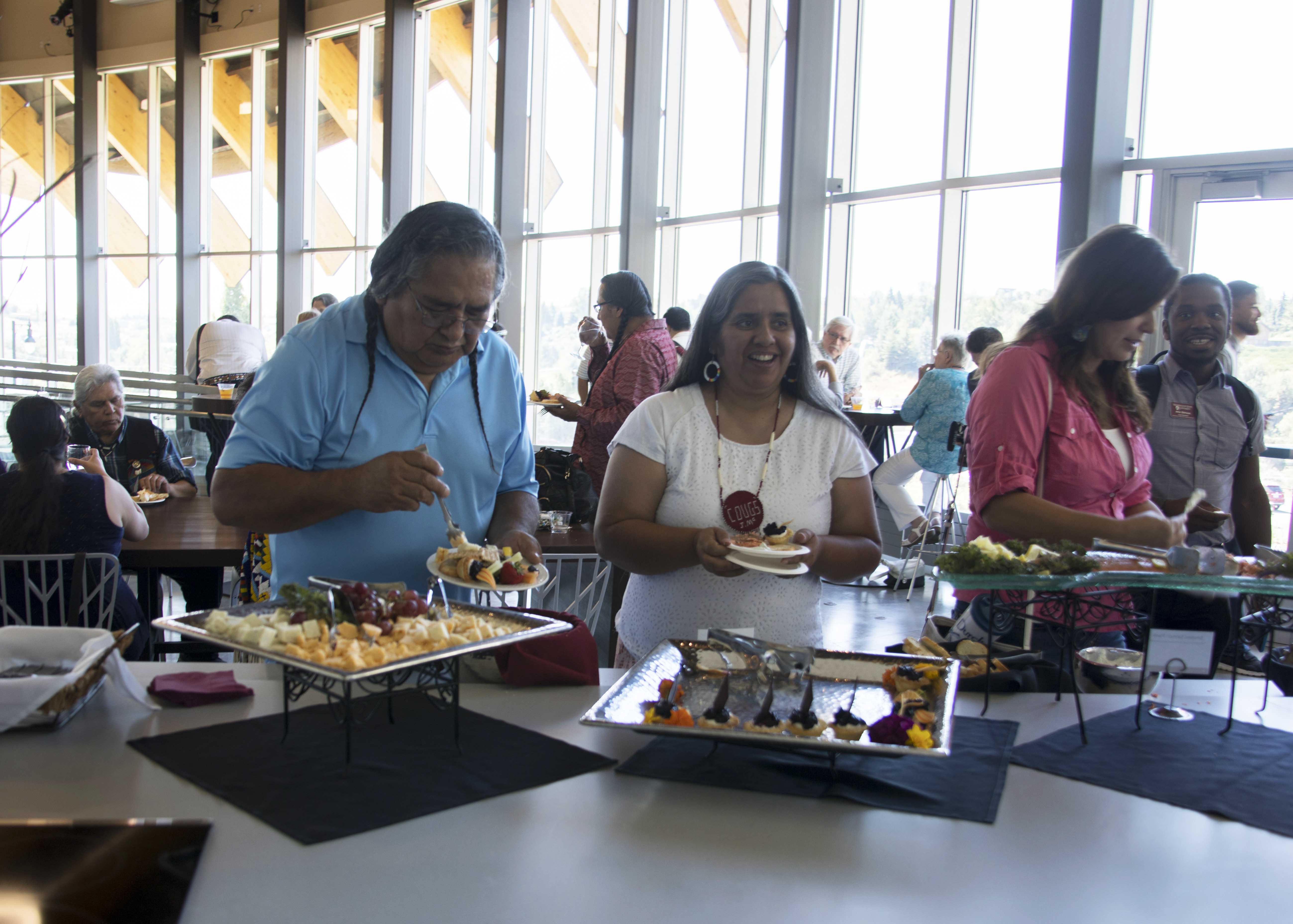 Guests enjoying light refreshments in the Cultural Center kitchen area.